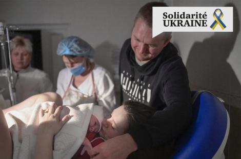Aleina and her husband hug their new-born Snizhana after giving birth in the maternity ward as sirens warn of air raids in Mykolaiv, 14 March 2022. Almost half of the 49 women have had to give birth in the basement since 24 February.
